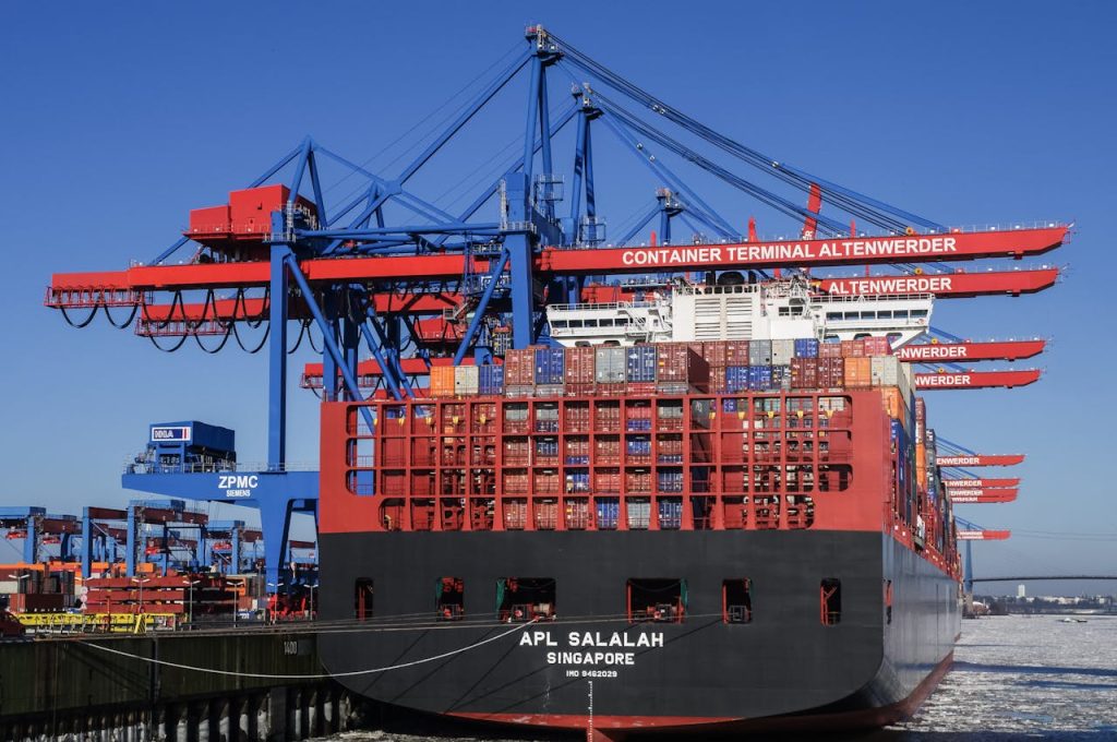A cargo ship at the Altenwerder terminal in Hamburg, showcasing global trade and container transportation.