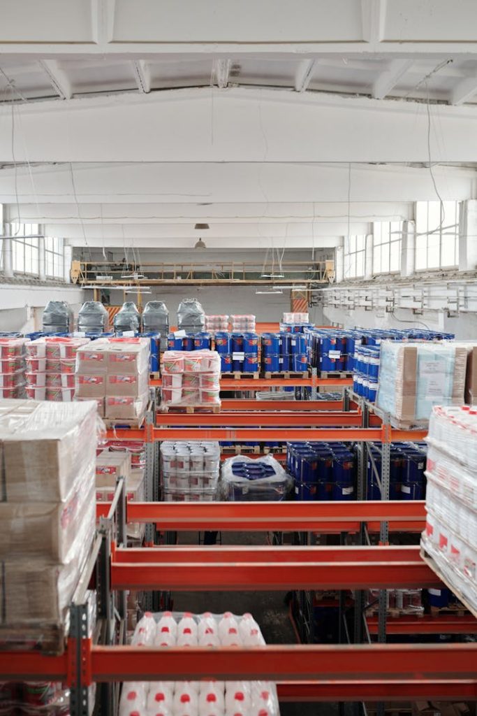 Mastering the First Impression: Your intriguing post title goes here Interior of a large warehouse with neatly organized goods on shelves, ready for shipment.